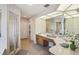 Bathroom featuring a walk-in shower, double vanity and tile floors at 1927 Curry Rd, Lutz, FL 33549