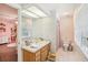 Well-lit bathroom features a single sink, tiled floor and shower-tub combination at 1927 Curry Rd, Lutz, FL 33549