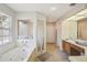 Spacious bathroom features a walk-in shower, jetted tub and large vanity at 1927 Curry Rd, Lutz, FL 33549