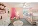 Pink bedroom with bunk beds, ceiling fan, walk in closet and neutral carpet at 1927 Curry Rd, Lutz, FL 33549