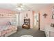 Bedroom with bunk beds, carpet, ceiling fan, pink walls and a window seat at 1927 Curry Rd, Lutz, FL 33549