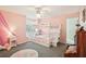 Bedroom with pink walls, bunk beds, ceiling fan and carpeted floor at 1927 Curry Rd, Lutz, FL 33549