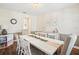 Elegant dining room featuring a long white table, stylish chairs, and soft pastel accents for a refined atmosphere at 1927 Curry Rd, Lutz, FL 33549
