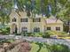 Charming two-story home with lush landscaping, a well-manicured lawn, and a welcoming front entrance at 1927 Curry Rd, Lutz, FL 33549