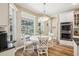 Eat in kitchen featuring a breakfast nook with backyard views, stainless appliances, and white cabinets at 1927 Curry Rd, Lutz, FL 33549