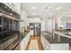 Bright kitchen with granite counters, stainless steel appliances, white cabinetry and modern fixtures at 1927 Curry Rd, Lutz, FL 33549