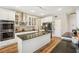 Modern kitchen featuring stainless steel appliances, granite counters, and white cabinets at 1927 Curry Rd, Lutz, FL 33549