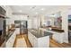 Open kitchen featuring granite countertops, stainless steel appliances, white cabinets and an island with a sink at 1927 Curry Rd, Lutz, FL 33549