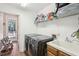 Functional laundry room with modern washer/dryer, sink, and ample storage shelving at 1927 Curry Rd, Lutz, FL 33549