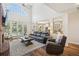 Airy living room with a brick fireplace, cathedral ceiling, access to the pool, and an open layout at 1927 Curry Rd, Lutz, FL 33549