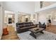 Expansive living room with a view into the kitchen and featuring a leather sofa set and modern decor at 1927 Curry Rd, Lutz, FL 33549
