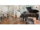 Piano room featuring a grand piano and large windows, creating a space filled with natural light and musical charm at 1927 Curry Rd, Lutz, FL 33549