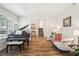 Cozy living room featuring a grand piano, comfortable seating, and a staircase view at 1927 Curry Rd, Lutz, FL 33549