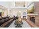 Spacious living room featuring a brick fireplace, built-in shelves, and an open view to the entryway and stairs at 1927 Curry Rd, Lutz, FL 33549