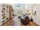 Bright living room with a brick fireplace, built-in shelves, high ceilings, and access to the pool area at 1927 Curry Rd, Lutz, FL 33549