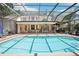 View of the screened pool and the rear of the home at 1927 Curry Rd, Lutz, FL 33549