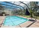 Cool off in this backyard pool with a screened enclosure for year-round enjoyment at 1927 Curry Rd, Lutz, FL 33549