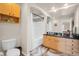 Well-lit bathroom with a tub/shower combo, wood-style cabinets, and modern fixtures at 200 4Th S Ave # 303, St Petersburg, FL 33701