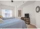 Bright second bedroom features two beds, side table, lamp, dresser with TV and window at 200 4Th S Ave # 303, St Petersburg, FL 33701