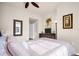 Bright bedroom features neutral walls, ceiling fan, mirror and dresser with TV and wall art at 200 4Th S Ave # 303, St Petersburg, FL 33701