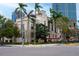 Corner view of a vintage style building with palm trees, and a modern building in the background at 200 4Th S Ave # 303, St Petersburg, FL 33701