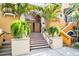 Inviting building entrance features tiled steps, lush greenery, and secure doorway at 200 4Th S Ave # 303, St Petersburg, FL 33701
