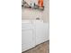 Laundry room features side-by-side washer and dryer with wire shelving above at 200 4Th S Ave # 303, St Petersburg, FL 33701