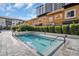 Community pool featuring blue tiles, manicured bushes and palm trees adding a tranquil resort style to the living experience at 200 4Th S Ave # 303, St Petersburg, FL 33701