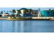 Beautiful waterfront featuring a modern structure with palm trees and reflections in the calm water at 200 4Th S Ave # 303, St Petersburg, FL 33701