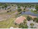 Aerial view of home near multiple ponds and walking trails surrounded by mature trees and lawns at 2309 New Orchard Ct, Sun City Center, FL 33573