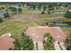Serene aerial view of a residential community surrounded by lakes, golf courses, and lush green spaces at 2309 New Orchard Ct, Sun City Center, FL 33573