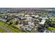 Overhead image of the complex showcasing the building, pool, tennis courts, parking, and surrounding landscaping at 2309 New Orchard Ct, Sun City Center, FL 33573