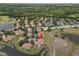Aerial view of home surrounded by ponds and mature trees in a well-established neighborhood at 2309 New Orchard Ct, Sun City Center, FL 33573