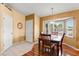 Cozy dining area with hardwood floors, a bay window, and a chandelier with seating for four at 2309 New Orchard Ct, Sun City Center, FL 33573