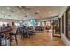 Spacious dining area with tables and chairs, multiple ceiling fans, and wall-mounted televisions at 2309 New Orchard Ct, Sun City Center, FL 33573
