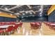 Large event space with wood floors, a stage, and rows of tables and chairs at 2309 New Orchard Ct, Sun City Center, FL 33573