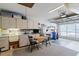 A well-organized garage featuring built-in cabinets, workspace, and natural light from the open garage door at 2309 New Orchard Ct, Sun City Center, FL 33573