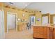 Spacious kitchen with tile flooring, light wood cabinets, built-in storage, and direct access to other rooms at 2309 New Orchard Ct, Sun City Center, FL 33573