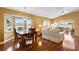 Inviting living room and dining area with hardwood floors, vaulted ceilings, and plenty of natural light at 2309 New Orchard Ct, Sun City Center, FL 33573