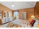 Comfortable main bedroom with a large window and ample storage space at 2309 New Orchard Ct, Sun City Center, FL 33573