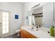 Bathroom with a single sink, door to the exterior, and shower with a glass door at 2513 Regal River Rd, Valrico, FL 33596