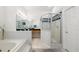 A bright bathroom featuring a soaking tub, glass shower, and dual vanity with tile flooring at 2513 Regal River Rd, Valrico, FL 33596