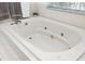 Close up of a soaking tub with jets, providing a luxurious spa-like experience at 2513 Regal River Rd, Valrico, FL 33596