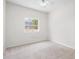 Light and airy bedroom showcases neutral carpeting and a window offering views of the well-kept outdoors at 2513 Regal River Rd, Valrico, FL 33596