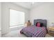 A cozy bedroom features a plaid bedspread and a bright window at 2513 Regal River Rd, Valrico, FL 33596