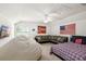 Spacious bedroom with a fan, a large sofa, a beanbag chair, and carpeted flooring at 2513 Regal River Rd, Valrico, FL 33596