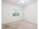 Neutral bedroom features wall-to-wall carpeting and a window offering views of the outdoor greenery at 2513 Regal River Rd, Valrico, FL 33596