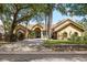 Attractive single Gathering home featuring a well-kept lawn and mature landscaping, enhancing curb appeal at 2513 Regal River Rd, Valrico, FL 33596