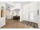 Inviting foyer with double doors, wood-look tile flooring, and an open view to the dining area at 2513 Regal River Rd, Valrico, FL 33596