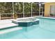 Hot tub connected to screened-in pool with bright light-blue water at 2513 Regal River Rd, Valrico, FL 33596